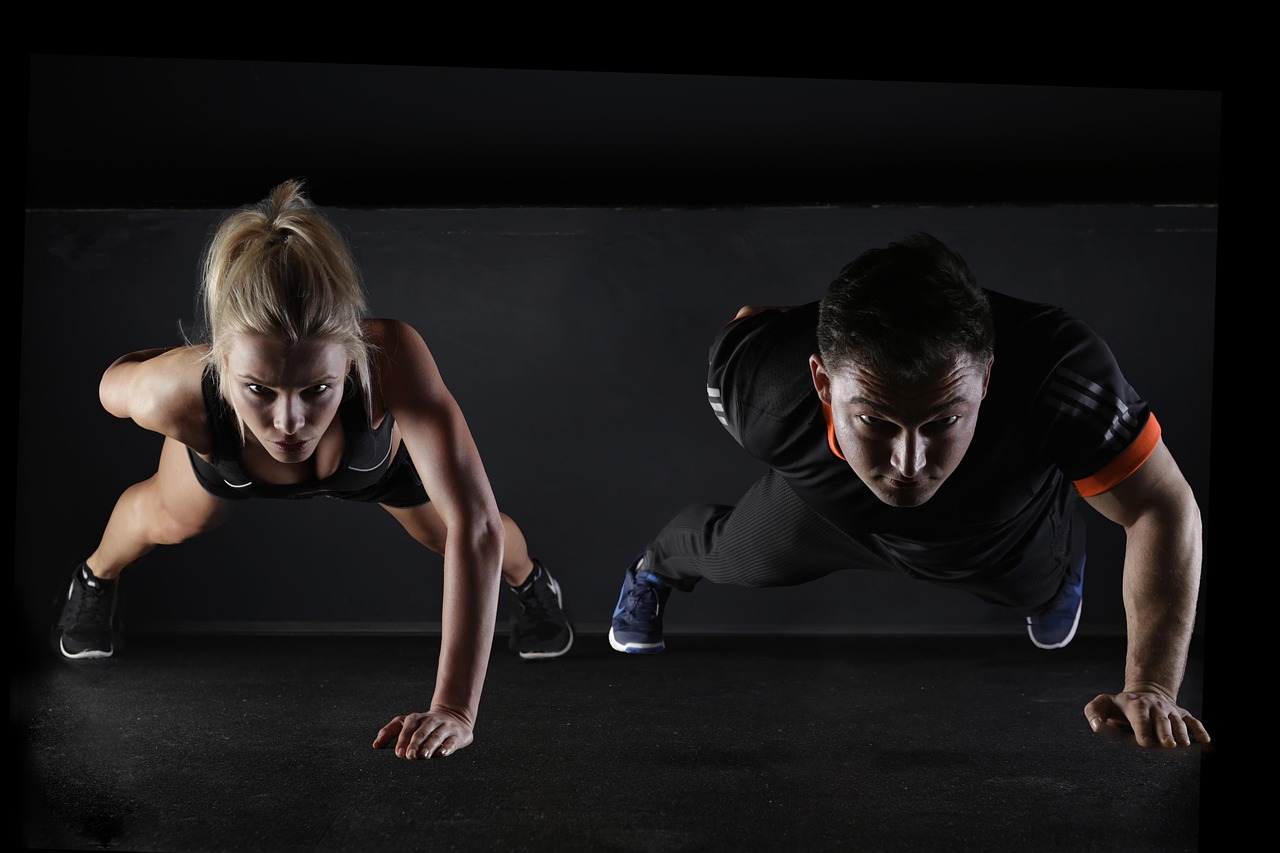 Man, woman, push-ups — Breaking Down Monthly TRT Costs to Fit Your Budget and Health Goals