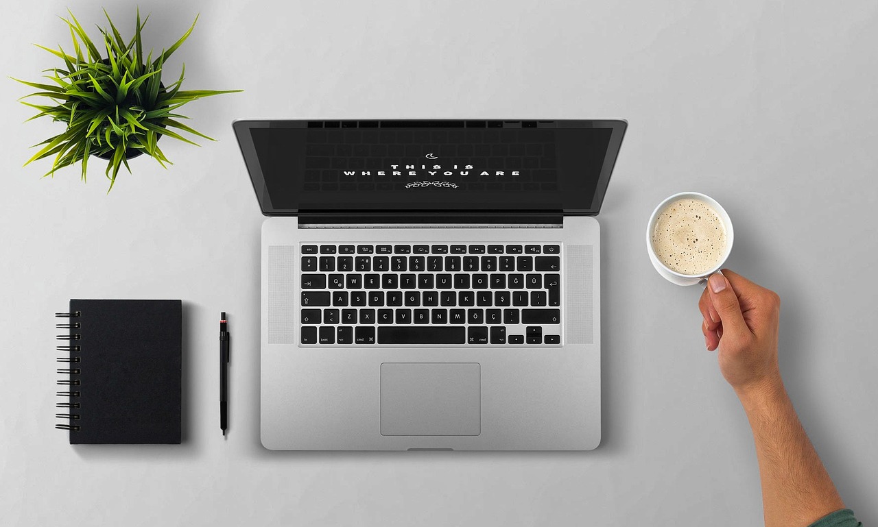 Laptop, coffee, arm — Confide in Internet Business Marketing Training?