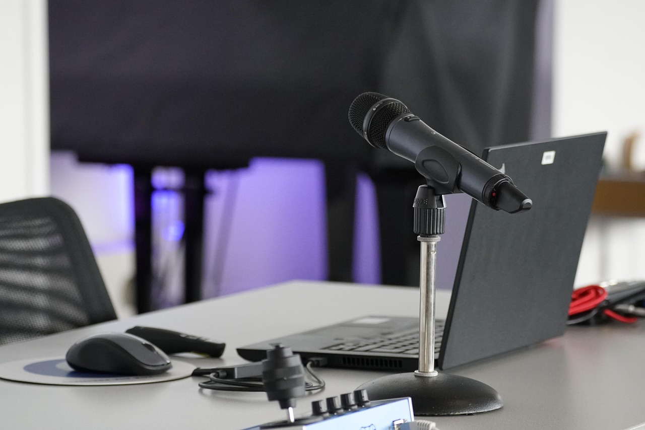 Laptop, conference table, mouse — SkySnap: Your Premier Aerial Videography and Photography Partner in Canada